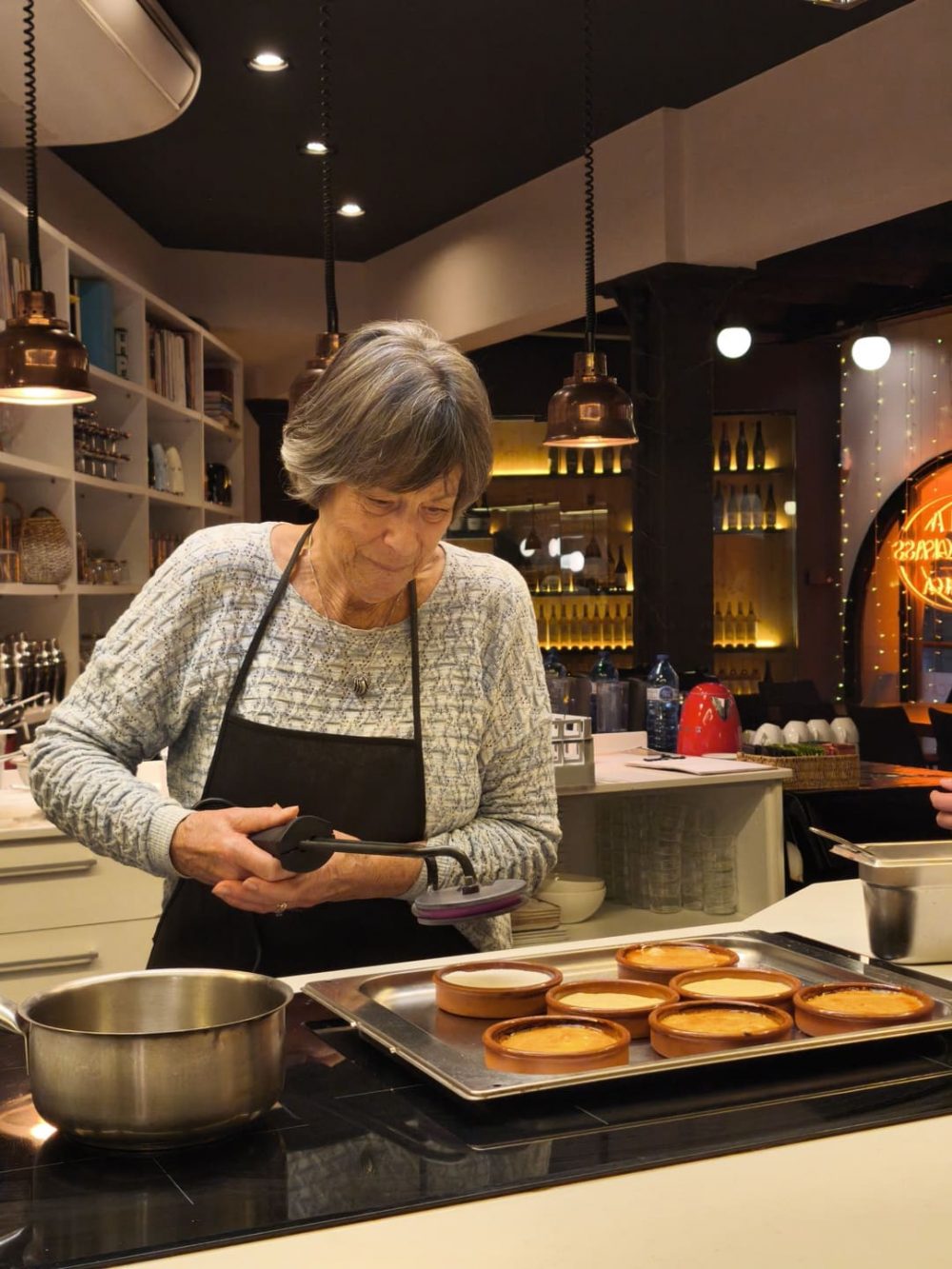 Guests preparing dessert during a Spanish cooking class in Barcelona