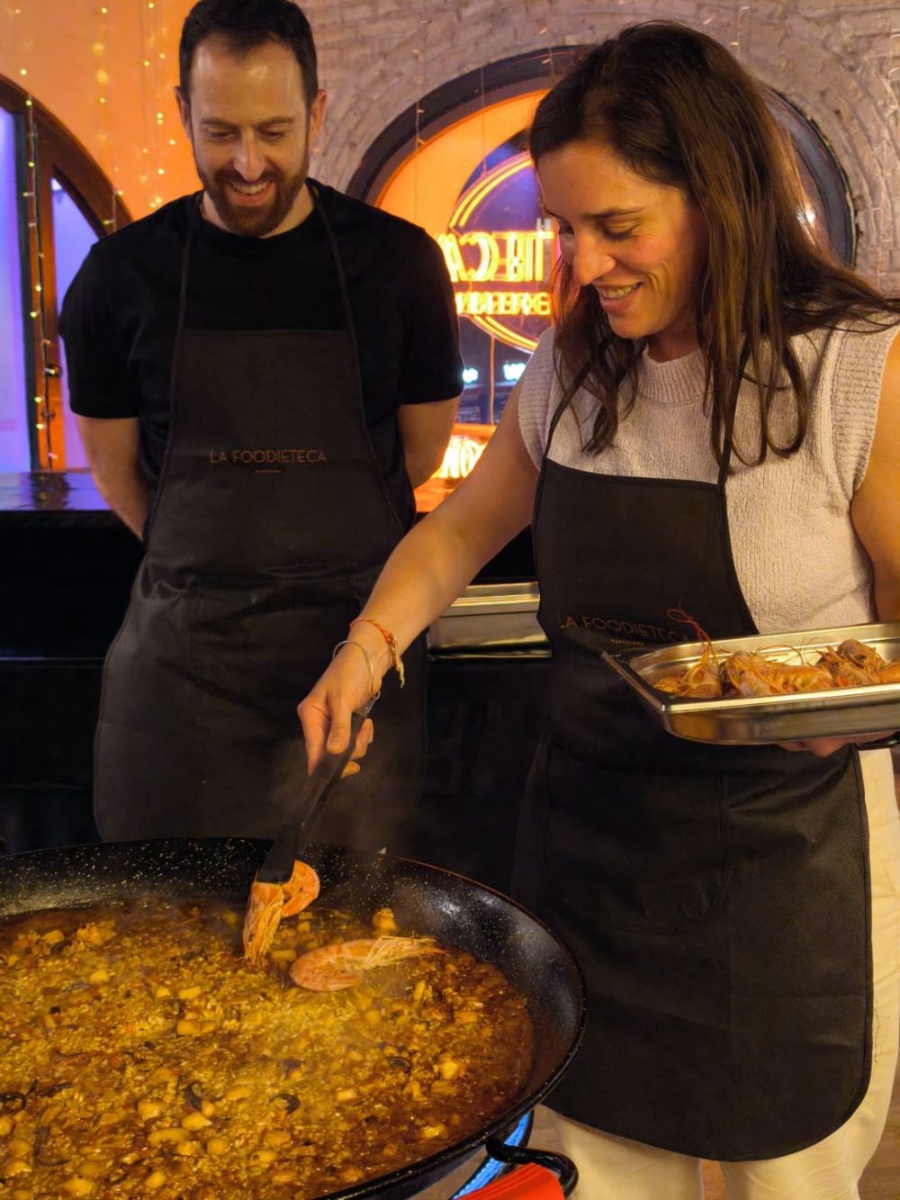 Guests serving paella during a Spanish cooking class in Barcelona