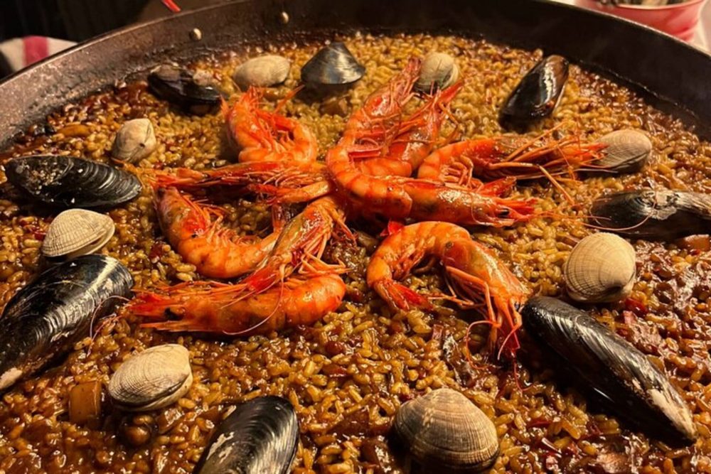 Authentic seafood paella prepared during the cooking class in Barcelona